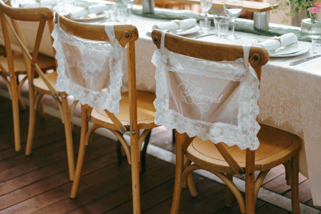 Lace-tied chairs at a wedding reception table