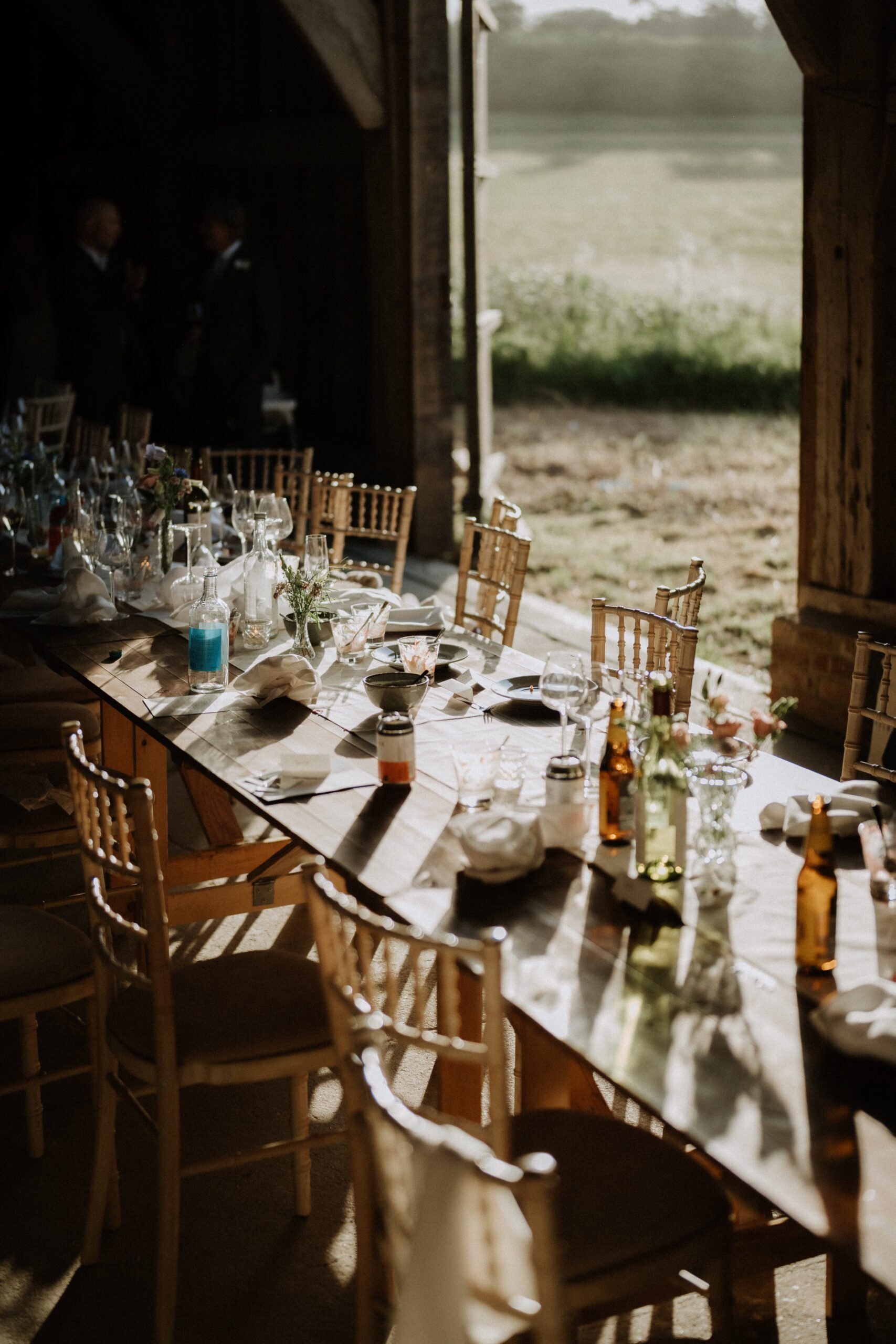 Black and white photograph of a barn reception table with countryside views